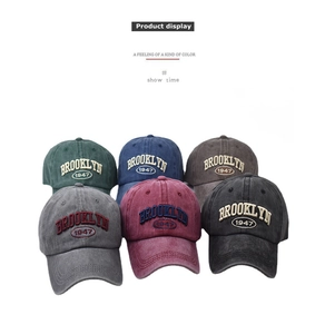Detailed display showing six colors of cotton baseball caps with Brooklyn 1947 embroidery