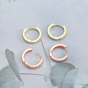 Macro view of micro-set cubic zirconia on gold and rose gold hoop earrings