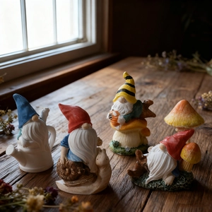 Gnome figurines set with snail and mushroom for garden decor on a vintage wooden table