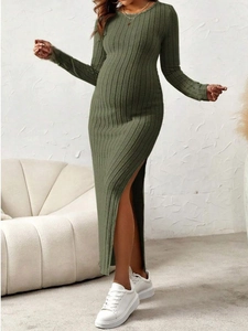 Detailed texture of olive green ribbed knit fabric and side high slit on maternity dress