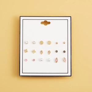 Vue à plat d'un ensemble de 9 paires de boucles d'oreilles avec alliage, strass et perles