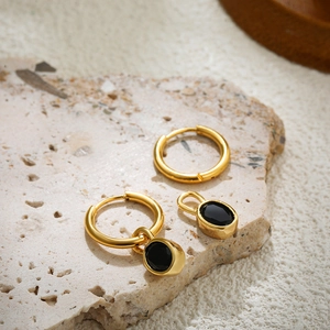 Close-up of 18K gold stainless steel hoop earrings with detachable black agate pendant