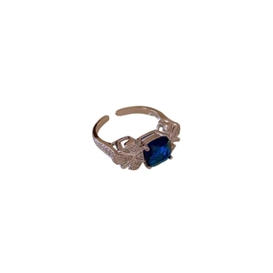 Adjustable leaf ring with blue square zircon and butterfly wing accents on white background