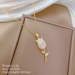 Close-up of golden tulip necklace with iridescent white flower and zircon leaf details