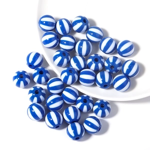 Detailed macro shot of 12mm blue and white striped round acrylic sports beads for DIY