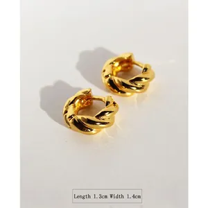 Minimalist twisted gold hoop earrings with matte finish measuring 1.3cm by 1.4cm