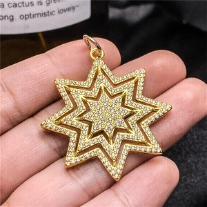 Detailed view of a gold-plated multi-layer star pendant with sparkling cubic zirconia inlay