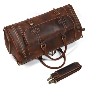 Detail of vintage crazy horse leather duffle bag with side pocket and shoulder strap