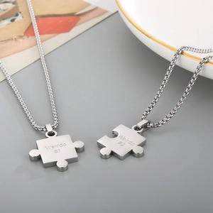 Couples stainless steel puzzle piece necklaces engraved with Weirdo 1 and Weirdo 2