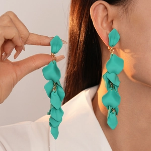 Detail showing long turquoise petal tassels and gold metal rings on a stylish clip-on earring
