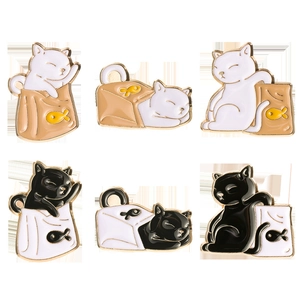 Set of six cute black and white cartoon cat enamel pins in various playful poses