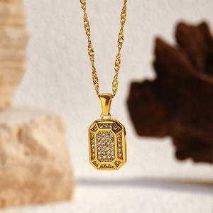 Macro detail of 18k gold plated butterfly necklace featuring pavé zircon octagon pendant
