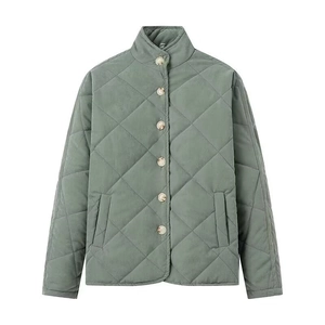 Detailed view of green diamond quilted jacket featuring a stand collar and button closure