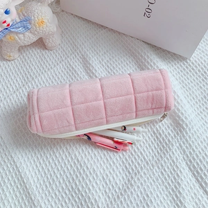 Detail of pink quilted plush pencil case showing soft texture and storage capacity