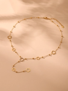 Close-up of gold flower necklace with cubic zirconia pavé setting and lobster clasp