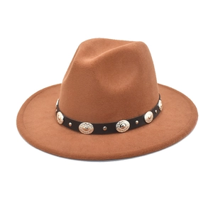 Detail of brown fedora hat with black leather band and silver metallic studs decoration