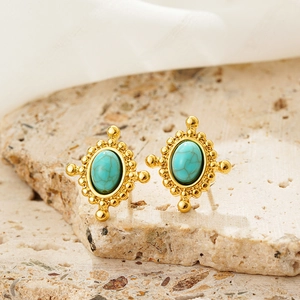 Close-up of vintage oval turquoise earrings in an 18K gold-plated bohemian setting