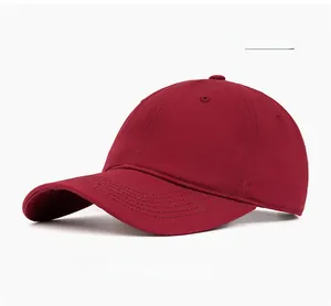 Detail view of burgundy cotton baseball cap with six-panel structure and curved brim