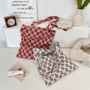 Detailed close-up of floral canvas tote bags with elegant flower patterns and sturdy handles