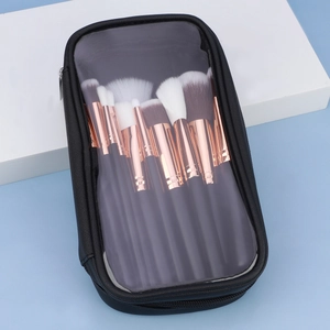 Detail of makeup brush set with rose gold ferrules in a transparent zipper travel pouch