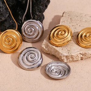 Elegant 18K gold and silver plated spiral swirl stud earrings and necklace set on stone