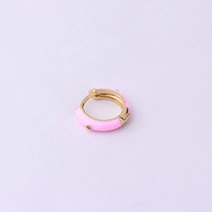 Detailed view of pink enamel hoop earring with gold dots on professional background
