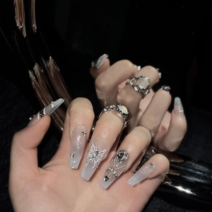 Artistic press-on nails with silver butterflies, pearls and metal chains on mirror surface