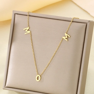 Detailed view of 18K gold plated MOM letter pendant on a delicate chain necklace