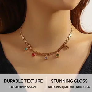 Detailed close-up of gold choker chain with five colorful rhinestone heart pendants