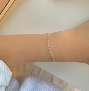 Close-up of a minimalist S925 sterling silver chain bracelet with delicate round ring links