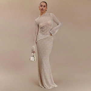 Detail of sheer beige lace long sleeve top and matching slim fit skirt two-piece set