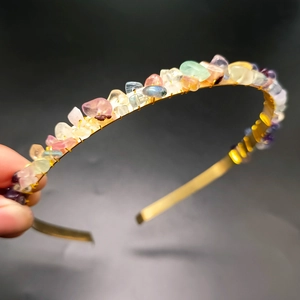 Detail showing hand-tied colorful natural crystal stones on a golden crown headband