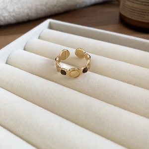 Macro shot of 18k gold plated tiger eye ring on white velvet jewelry tray display