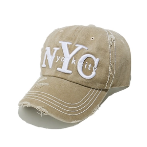 Close-up of NYC 3D embroidery and vintage distressed details on khaki baseball cap