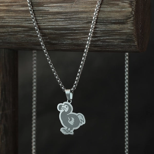 Vintage stainless steel dodo bird pendant necklace with box chain on wood stand