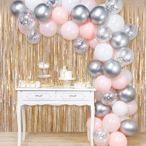 Balloon arch kit with pink and silver metallic balloons on laser fringe curtain backdrop