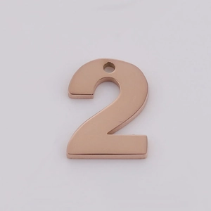 Detailed view of rose gold number 2 pendant with mirror-finish stainless steel surface