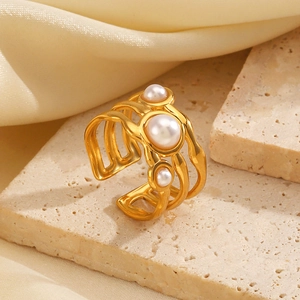 Irregular golden layered open ring with three white pearls on silk background