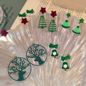 Christmas stud earrings set with festive tree reindeer and bell charms on tray