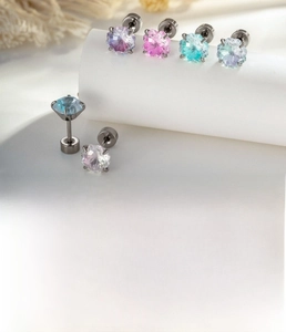 Macro detail of star-cut gradient zircon stud earrings with silver titanium steel pins
