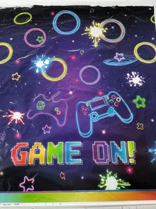 Neon video game party tablecloth featuring GAME ON text and galaxy controller design