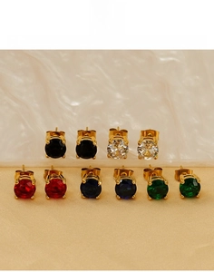 Detail of round titanium steel stud earrings with five colors and gold plated finish