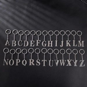 Set of 26 vintage stainless steel alphabet initial keychains in silver on black leather