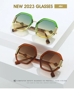 Detail of polygon metal sunglasses featuring gradient ocean lenses and gold frames