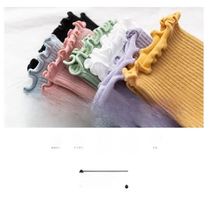 Detail of colorful knitted cotton socks with wavy ruffled edges in seven pastel colors