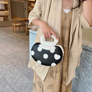Sweet black and white heart pattern crossbody bag with golden chain strap for women