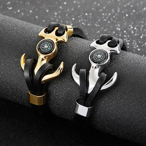 Nautical anchor leather bracelet with gold and silver compass accents on black woven cord