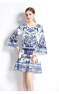 Detail of blue and white floral porcelain print on flared sleeves of a women's A-line dress