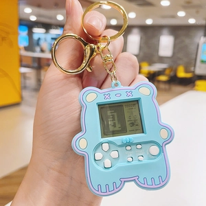Close-up of a blue bear-shaped mini Tetris game console keychain with a silicone texture
