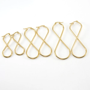 Three pairs of golden titanium steel infinity hoop earrings in various sizes on white backdrop